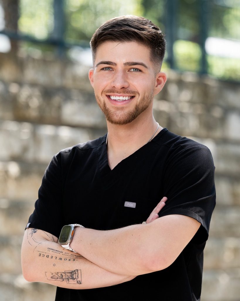 Portrait of Tyler Jackson, RN at TruMend Wound Care, in black scrubs